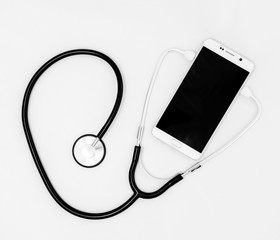 Fototapeta na wymiar Medical stethoscope tool over the surface of a mobile smart phon
