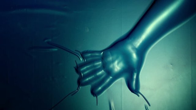 4k Halloween Shot of a Silhouette of Human Hand in Latex Vacuum