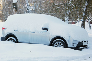 Car under the snow after a heavy snowfall