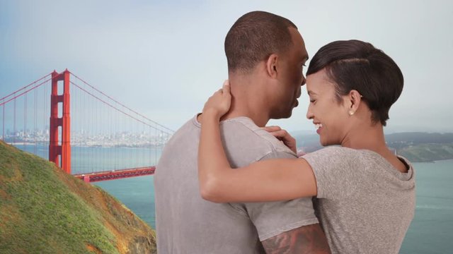 An African American couple embraces each other while looking out on San Francisco