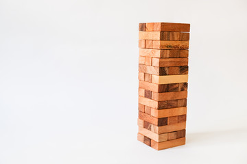 Wood block Stack tower game for children playing on wooden table with copyspace, Learning and Education background concept