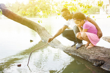 Fototapeta premium African American family playing around the lake