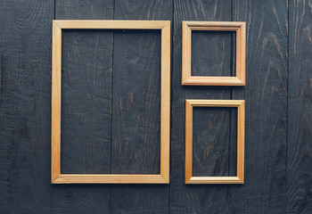 old frames on wooden wall