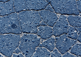 Blue toned damaged asphalt road texture.