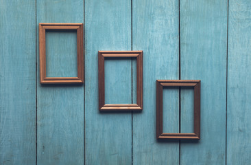 Fototapeta na wymiar old frames on wooden wall