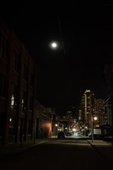 Fototapeta na wymiar Dark City Street at Night with Moon