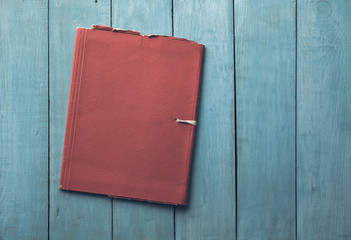 folder on blue wooden background