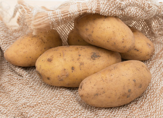 fresh potatoes on sacking