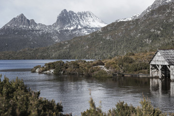 Fototapeta premium Boat shed in Dove Lake, Tasmania on a snowy and overcast day. 