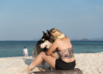 Girl with Siberian Husky at the beach