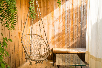 wooden chair in the room with sunset