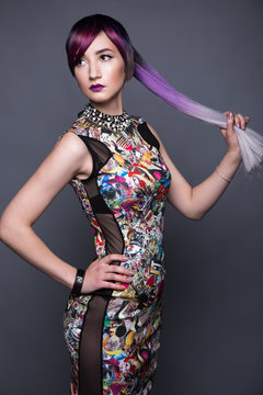 Beautiful girl in colorful dress with avant-garde hairstyles. Beauty the face. Photos shot in the studio.