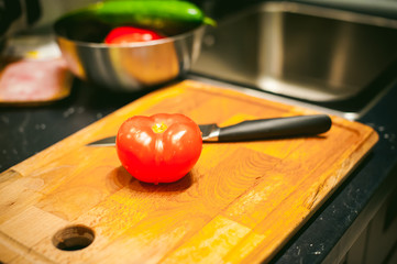 woman housewife in the kitchen. woman cuts vegetables, cooking, knife on a cutting board. Hands cooks close up