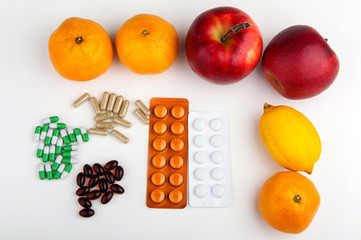 fruit and pill on white background