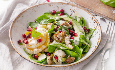 Salad with chicken, orange, spinach and pomegranate