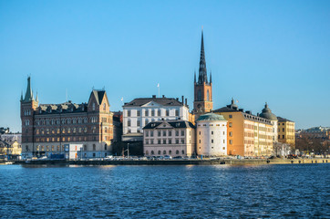 Panoramic view of the Old Town Riddarholmen island of Stockholm from Kungsholmen island. Birger Jarls white tower against clear sky