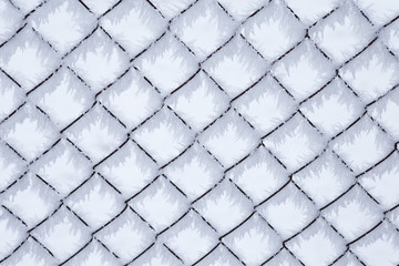 Wire fence covered by snow and ice crystals