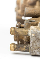 Old used dirty carburetor over white background