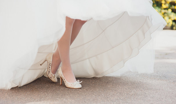 bride's legs visible under a beautiful wedding dress