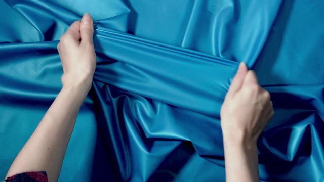 4k Shot of human Hands Stretching and Testing Latex Fabric