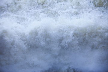 Water flowing from the open sluice gates of dam.