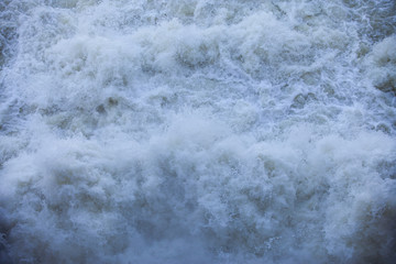 Water flowing from the open sluice gates of dam.