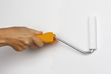 Close up of painter arm painting a wall with paint roller