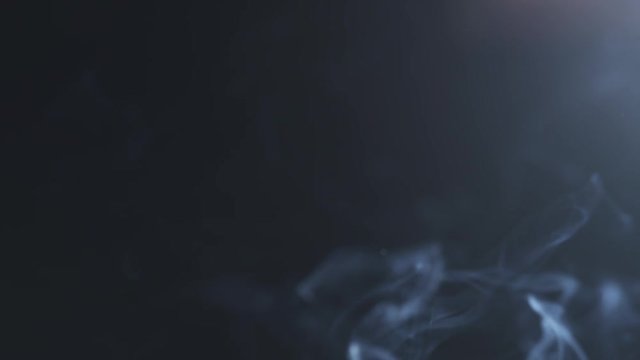 closeup blue smoke rising over black background in 180fps slow motion, prores footage