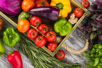 Set of raw vegetables in the wooden tray