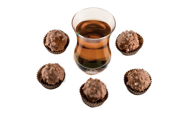 Glass with cognac and chocolate isolated on white background