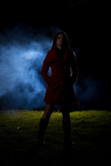 Fototapeta na wymiar spooky silhouette girl at night with smoke in background