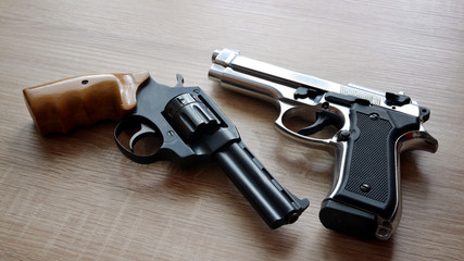 Two pistols on wooden board. - obrazy, fototapety, plakaty
