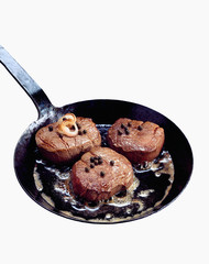 Steaks in frying pan