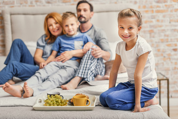 Happy family of four at home