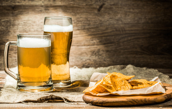 Beer in mug, glass on wooden table