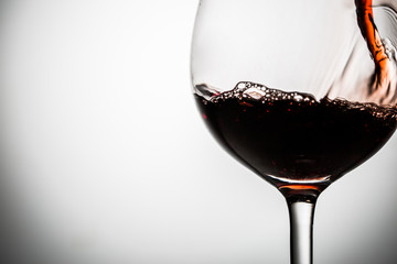 In glass on thin stalk called wine on empty background