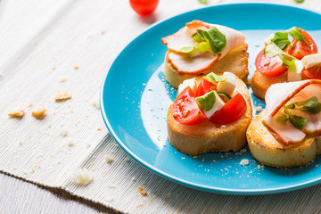 Bruschetta with tomato, cheese and bacon