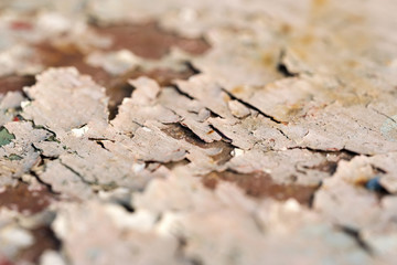 White cracked paint on rusty background, close-up