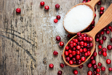 Fresh cranberry and sugar in spoons for homemade cranberry candy