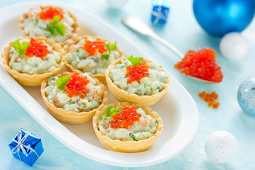 Christmas festive appetizer tartlets stuffed with salmon salad