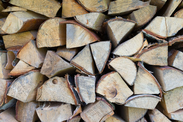 Fototapeta premium Background of dry chopped firewood logs in pile