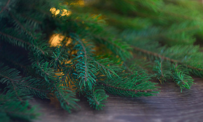 Christmas tree branch on a wooden background