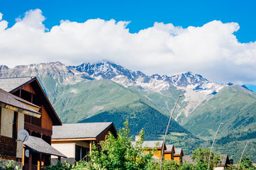 Fototapeta na wymiar Houses and mountains on the background in Mestia, Svaneti, Georgia