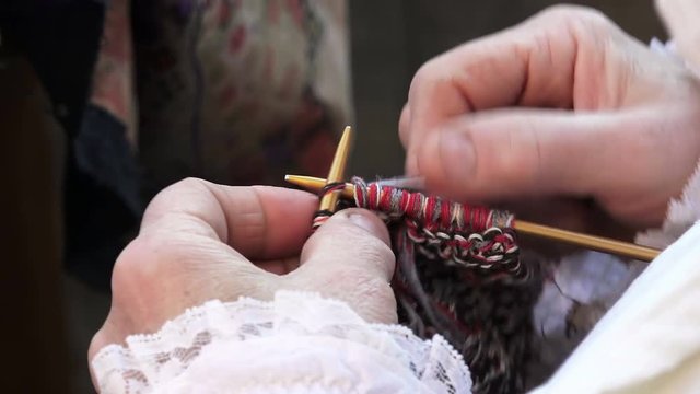detail of hands and knitting needles