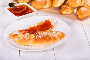Homemade cakes, bagel with peach jam on white background, closeup