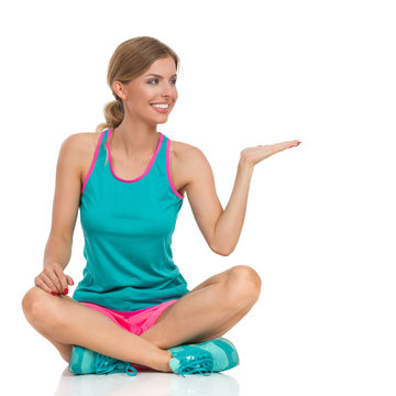 Sitting Woman In Vibrant Sports Clothes Presenting