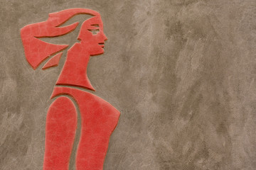 Red bas-relief with the image of a woman on a brown background