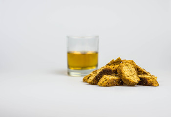 Italian cantucci and glass of vin santo liqueur, isolated on a white background