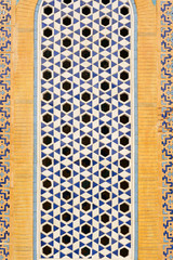 Beige, white and blue mosaic with hexagonal holes, background