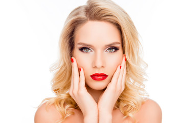 Beautiful blonde woman  with red lips and manicure touching her